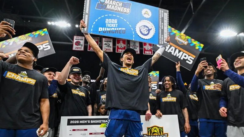 Queens men’s basketball players celebrating their ASUN Tournament championship