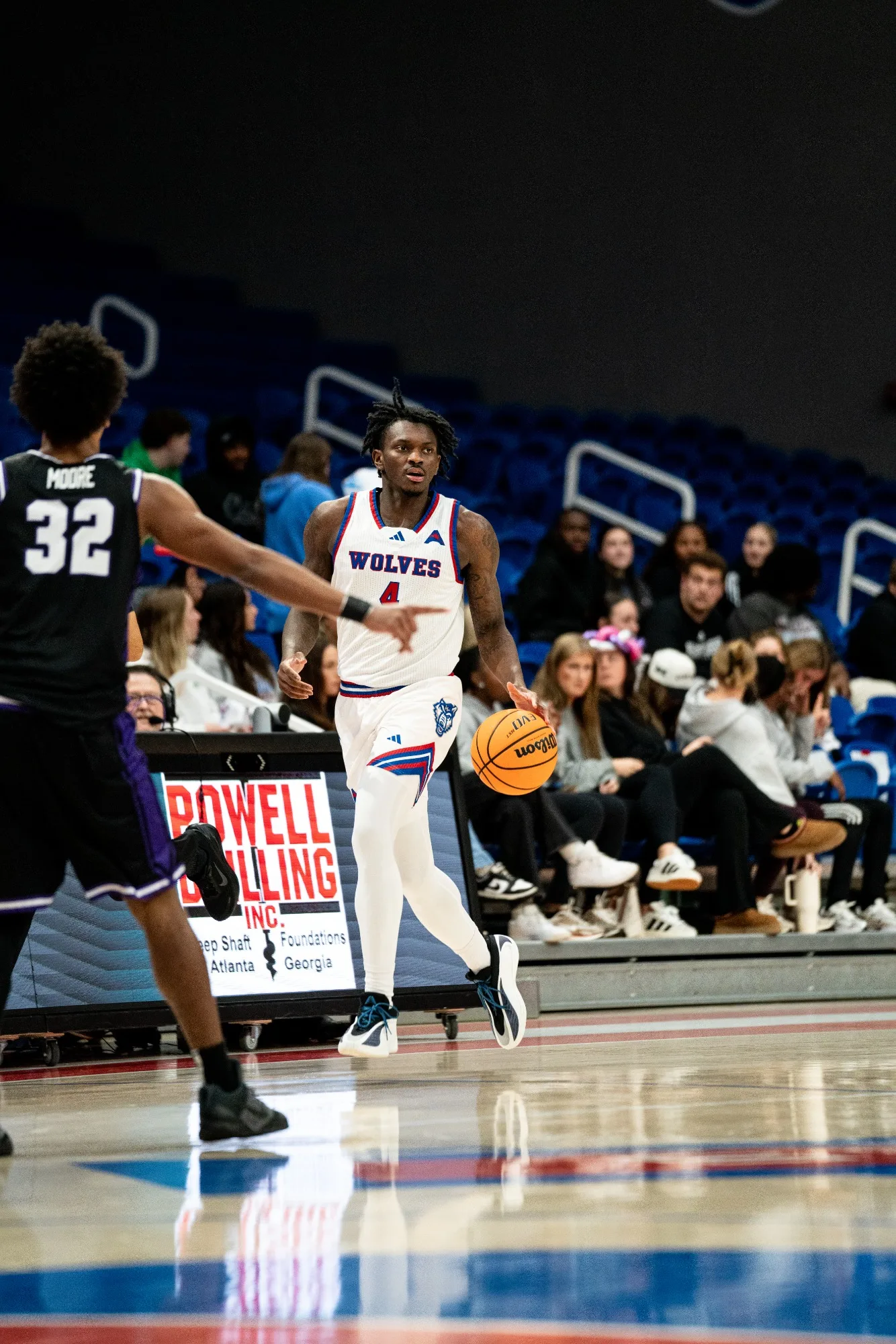 MBB vs UCA | Jan 22, 2026 Shelton Williams-Dryden, wearing a white home uniform, dribbles the ball down the court.