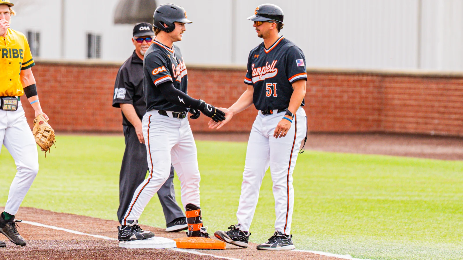 Campbell baseball staff and players on the field in Camels uniforms