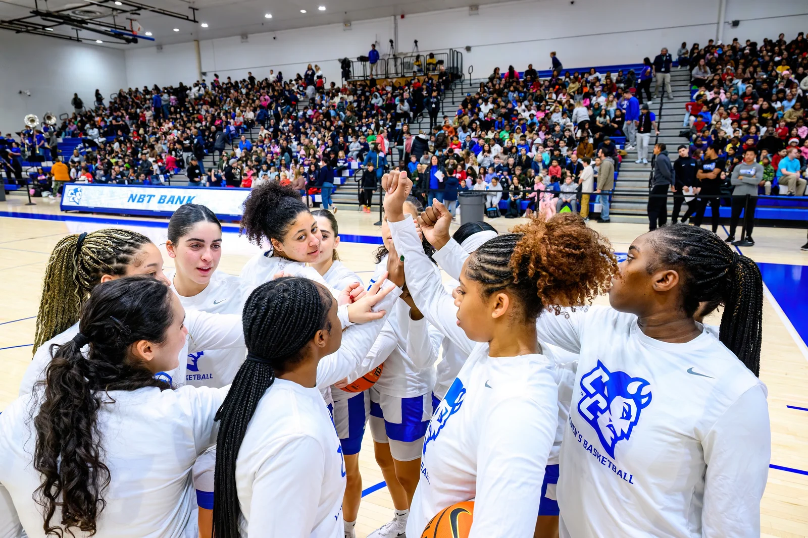 Central Connecticut women’s basketball players huddle at Detrick Gymnasium