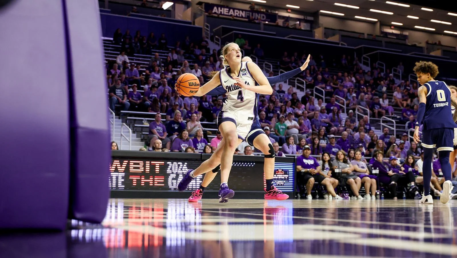 Kansas State forward Nastja Claessens drives against Georgia Tech in a white Wildcats uniform