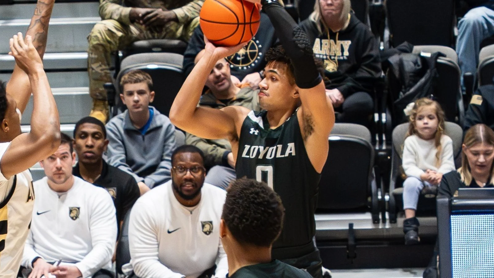A Loyola Maryland men's basketball player shoots in a black Greyhounds uniform against Army West Point