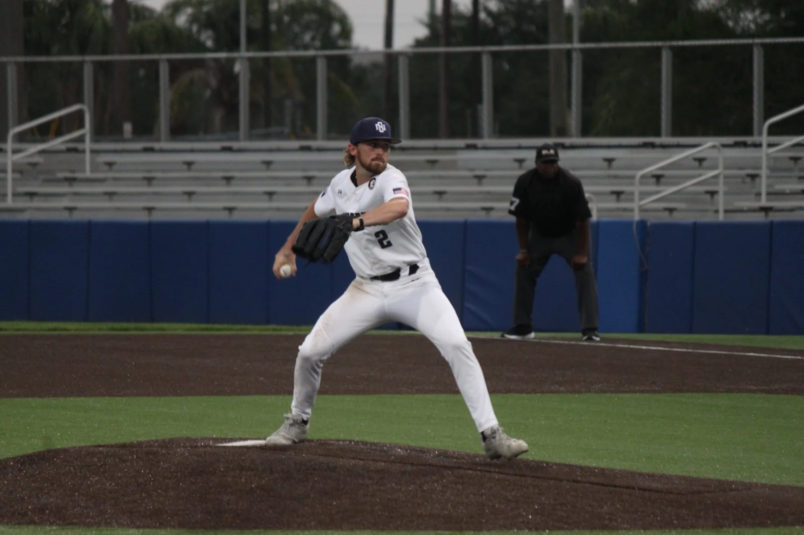 LSU New Orleans baseball pitcher Luke Lycette throws in a white Privateers uniform