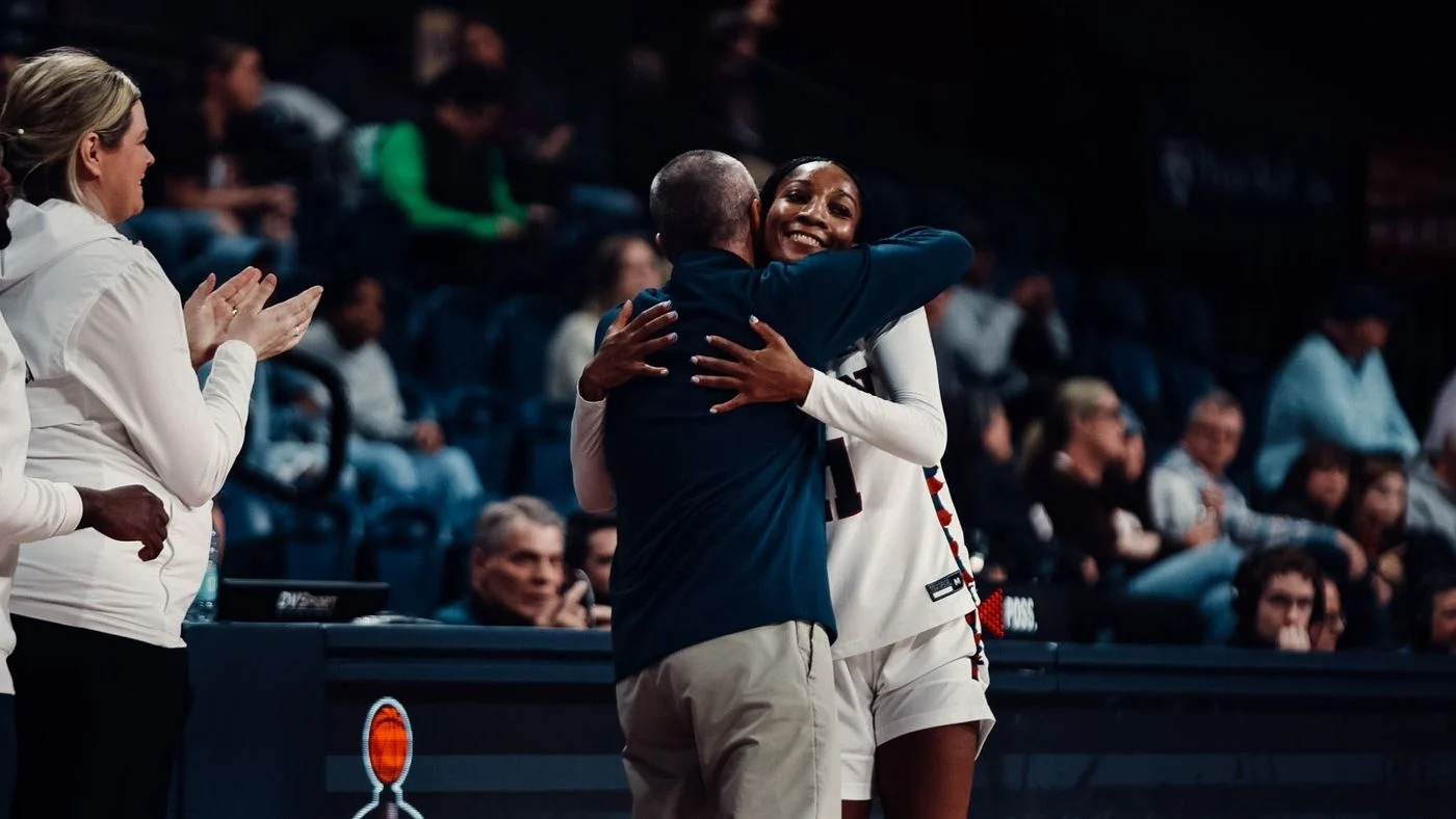 Penn guard Simone Sawyer celebrates with her coach at the Palestra
