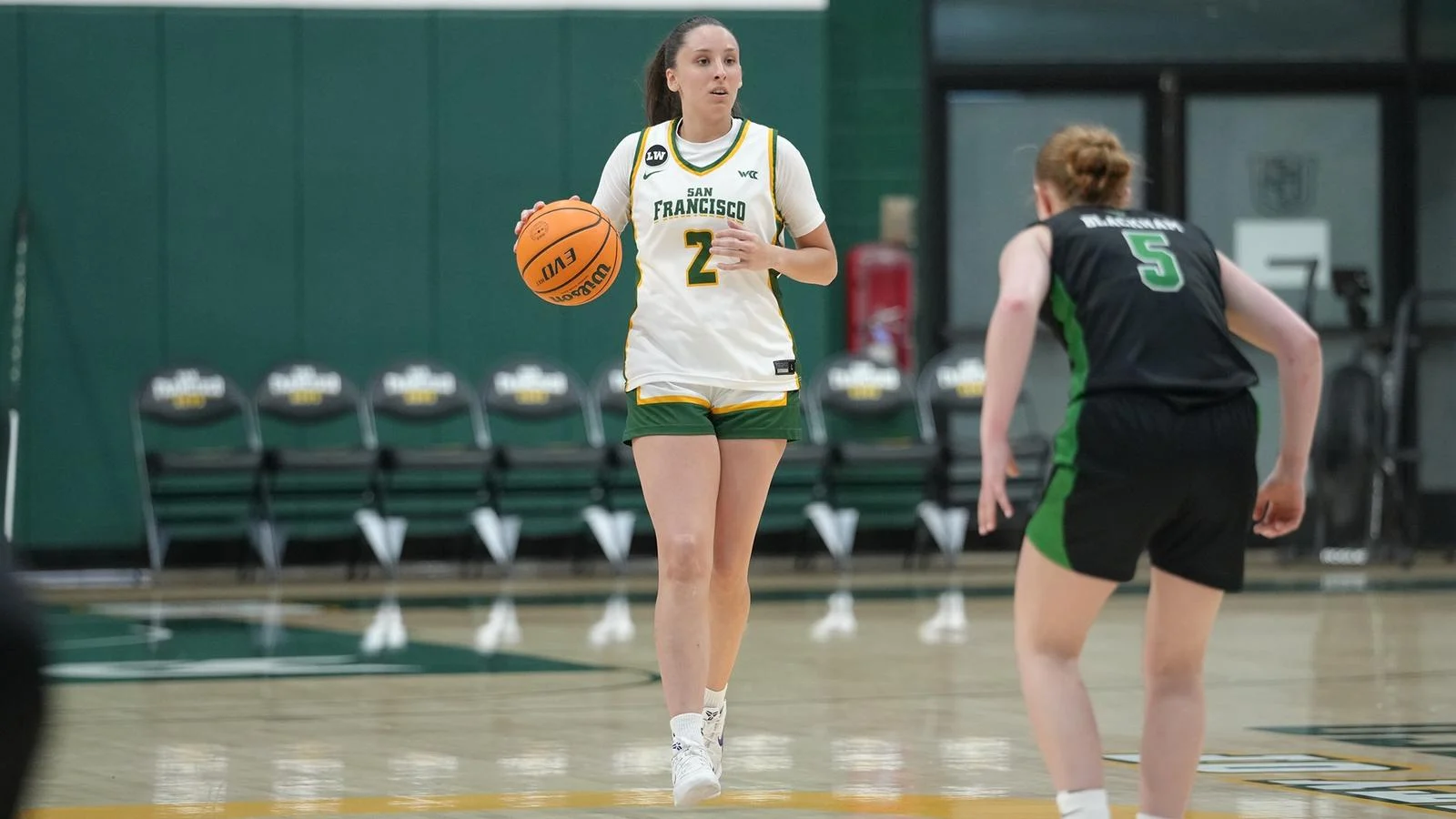 San Francisco guard Mara Neira dribbles against Utah Valley in a Dons uniform