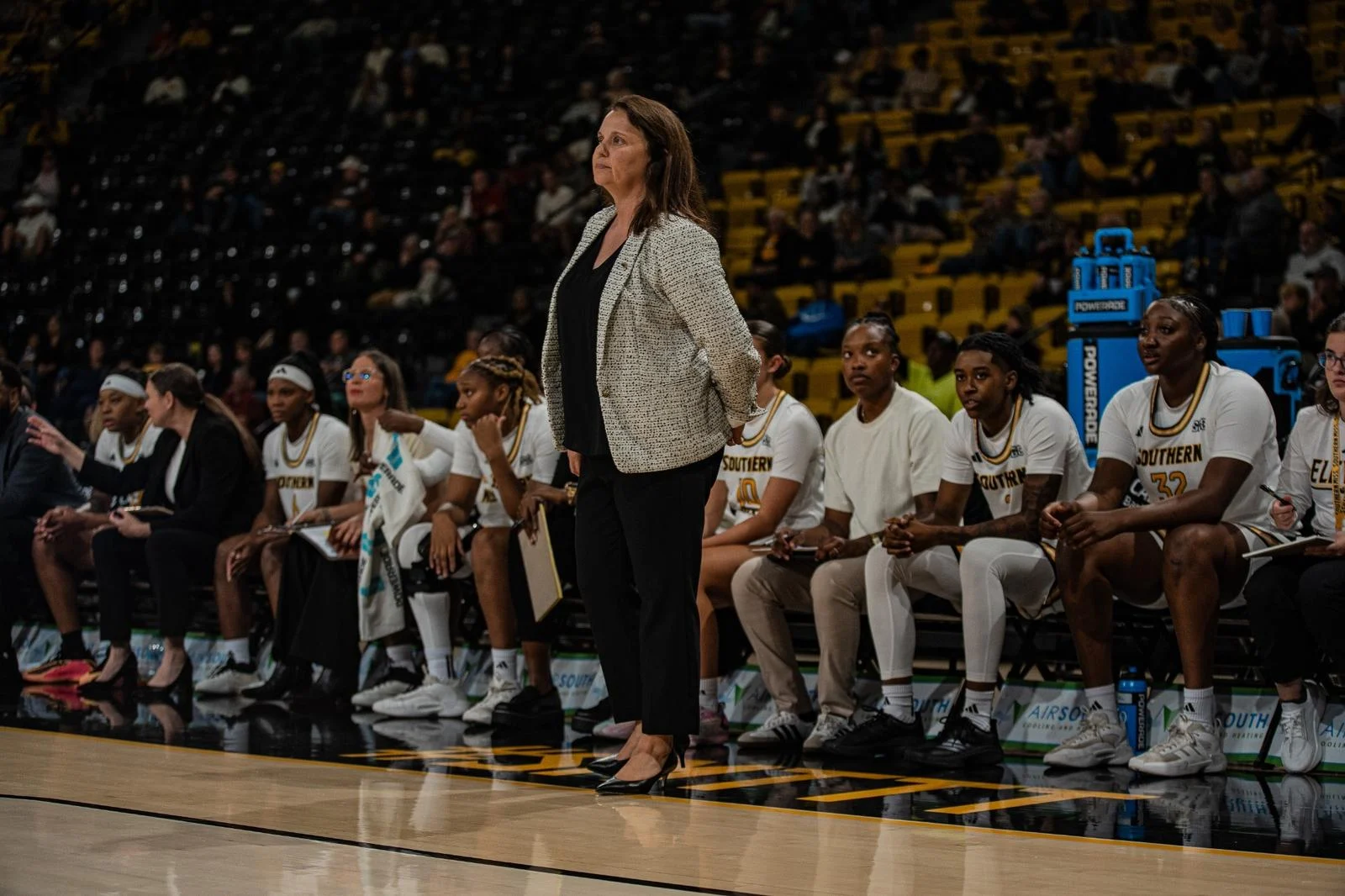 Missy Bilderback stands in front of the bench against Northern Illinois