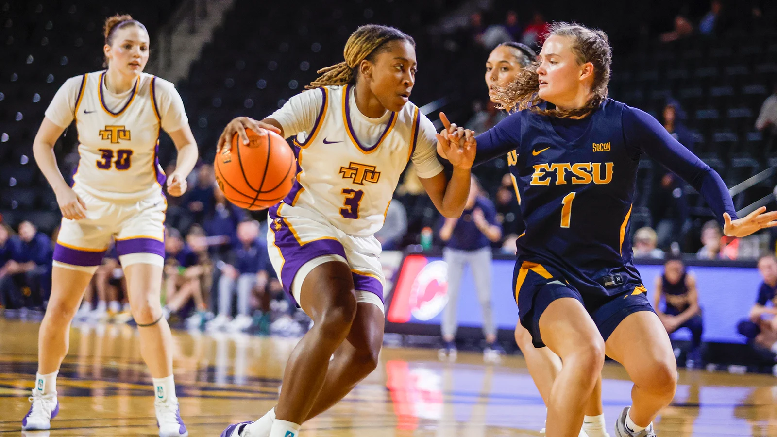 Tennessee Tech women’s basketball players in game action against East Tennessee State