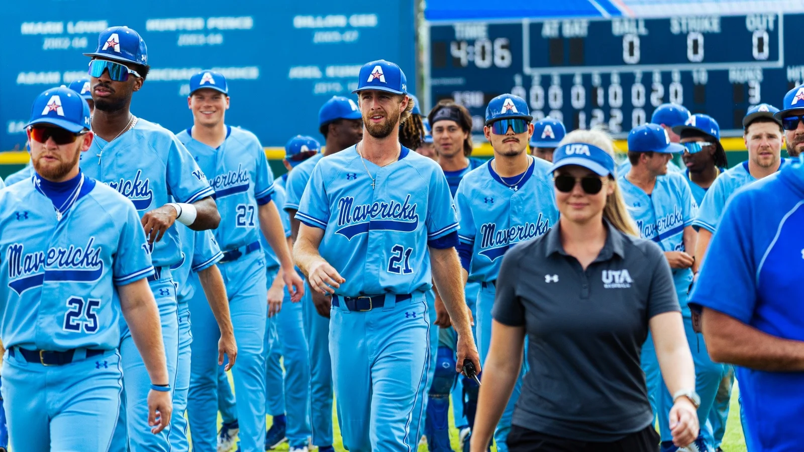 UT Arlington baseball players walk together in blue Mavericks uniforms