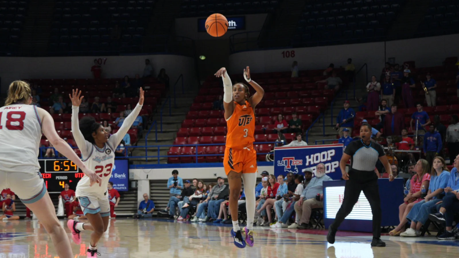 A UTEP women's basketball player shoots against Louisiana Tech in an orange Miners uniform