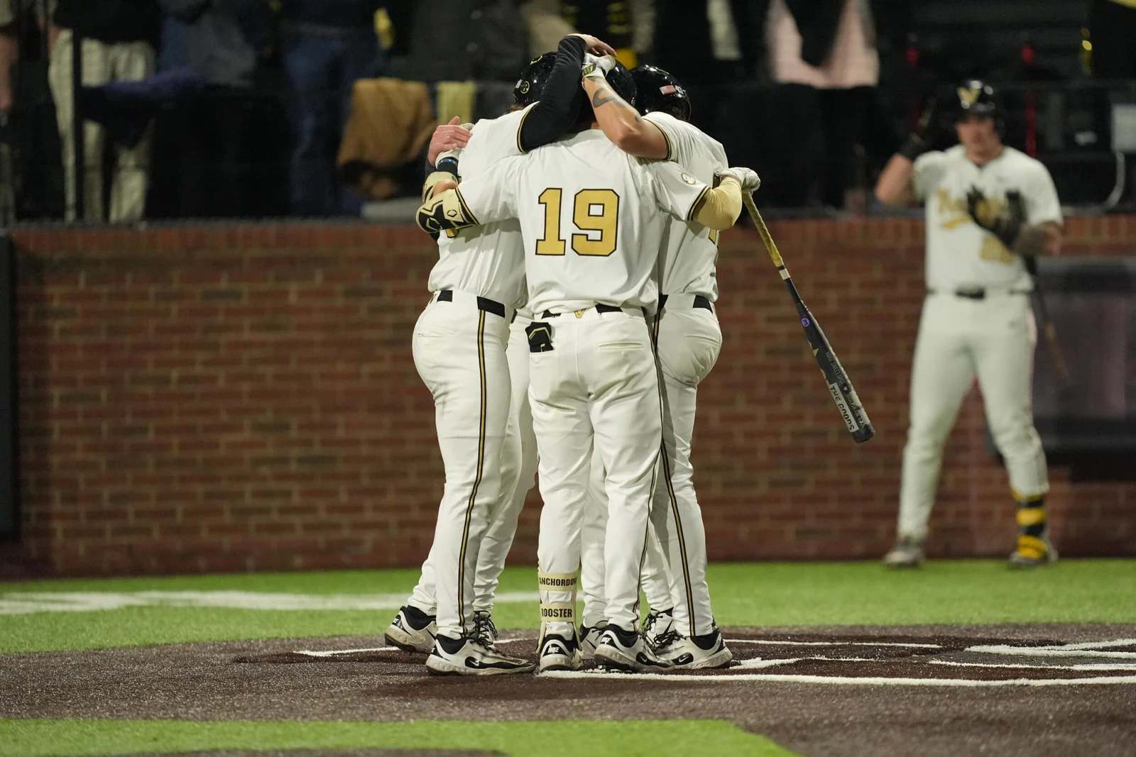Vanderbilt baseball players celebrate together in Commodores uniforms