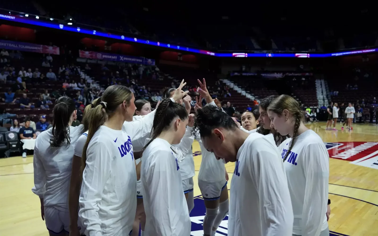 Villanova women's basketball players huddle together before a game