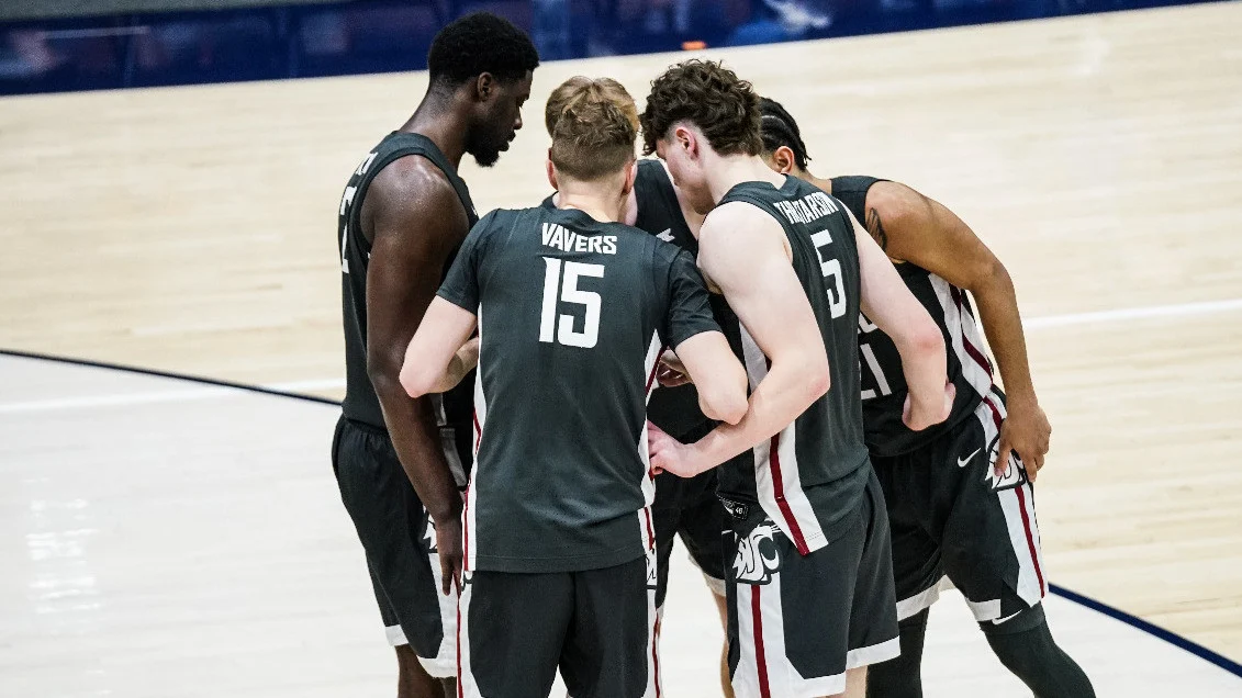 Washington State men's basketball players huddle during a game against Pepperdine.