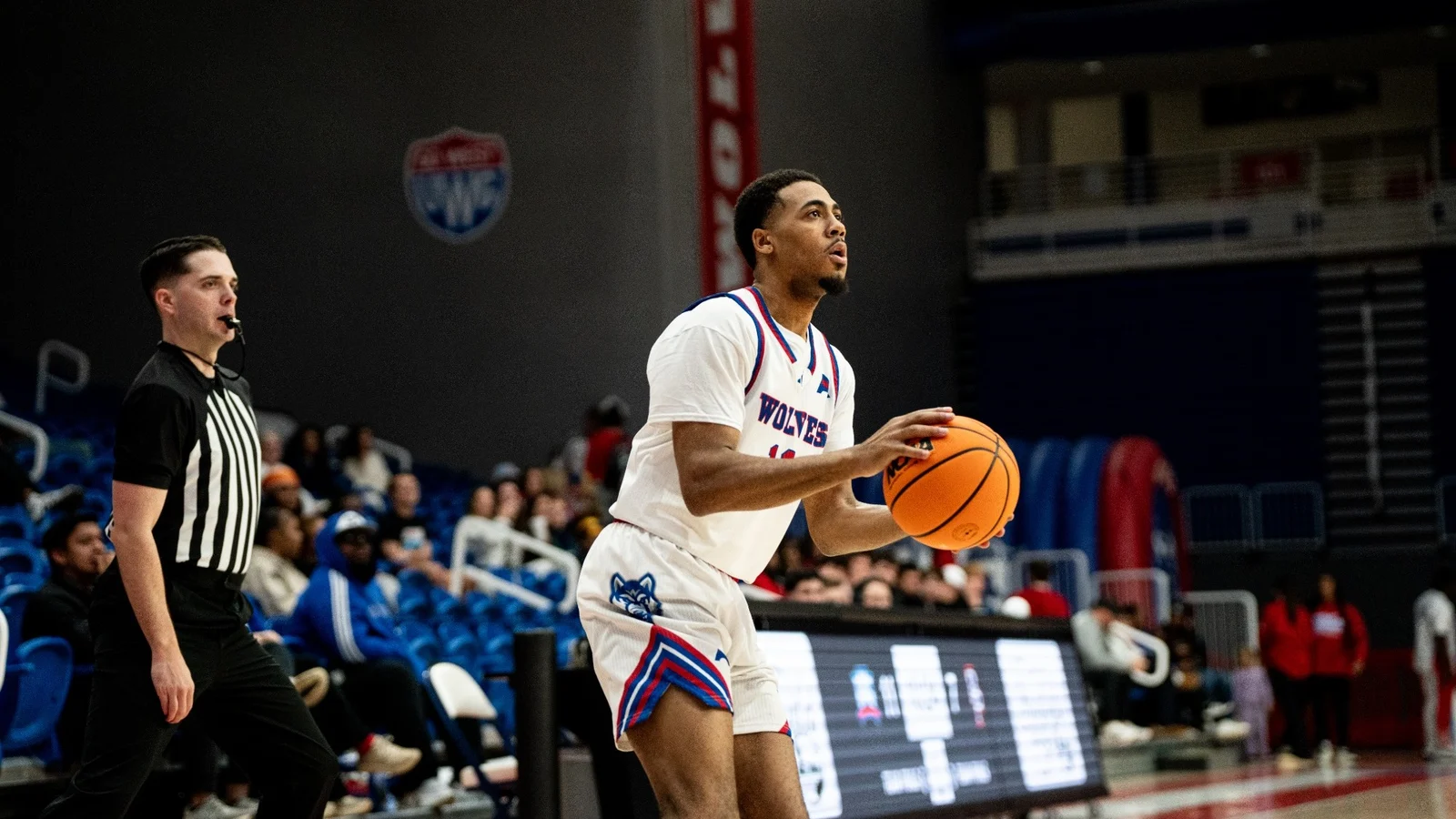 A West Georgia men's basketball player prepares a free throw in a white Wolves uniform at The Coliseum